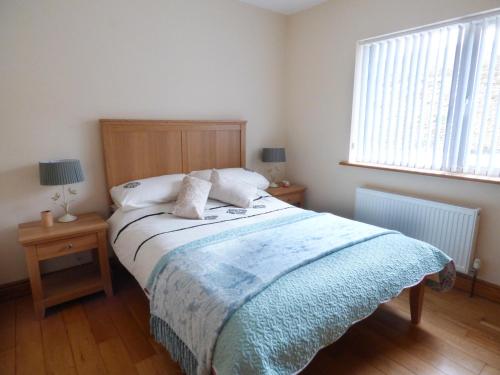 馬林的住宿－Gelmar's Coastal View，一间卧室配有一张带蓝色毯子的床