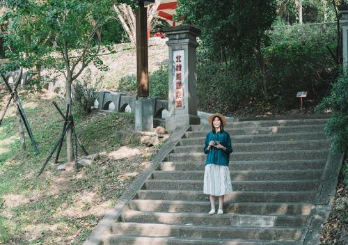 a woman is standing on some stairs at Hotel Royal Beitou in Taipei