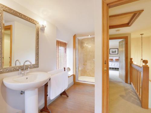 a bathroom with a sink and a mirror at Pittards Farm Cottage in Lambrook