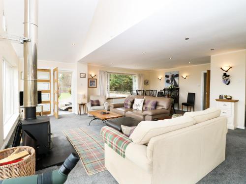 a living room with a couch and a fireplace at Torgorm in Glenelg