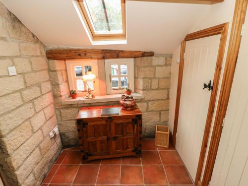 a small bathroom with a stone wall at The Old Chapel in Chesterfield
