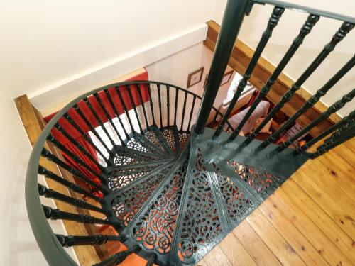 a spiral staircase with a red and black fan at The Old Chapel in Chesterfield