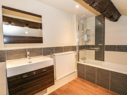 a bathroom with a sink and a shower and a tub at Eldon Country in Long Preston