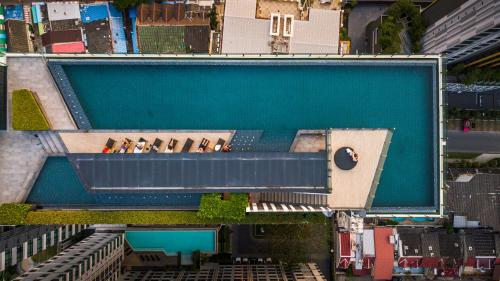 an overhead view of a large swimming pool at The Base Pattaya by Nami in Pattaya Central
