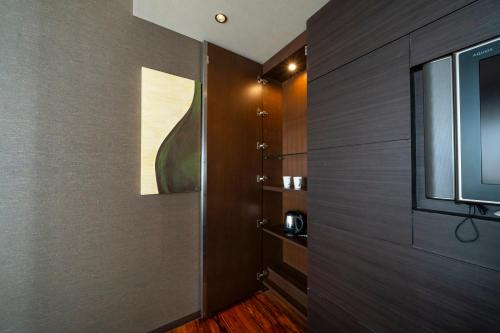 a hallway with a door with a television on it at KOKO HOTEL Fukuoka Tenjin in Fukuoka