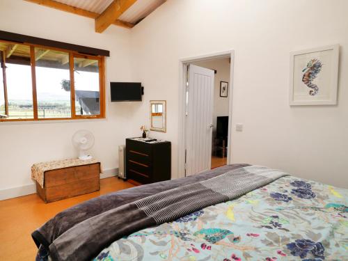 a bedroom with a large bed and a window at View The Gallery in Okehampton