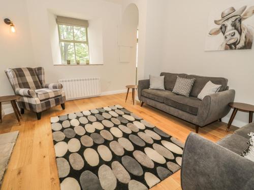 a living room with two couches and a rug at Oak Cottage in Barnard Castle