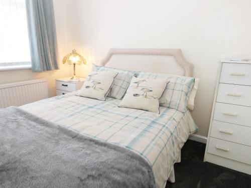 um quarto com uma cama com duas almofadas em Seaspray em Withernsea