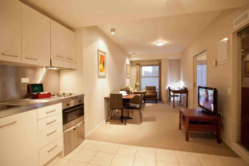 a kitchen and living room with a dining room at VR Auckland City in Auckland