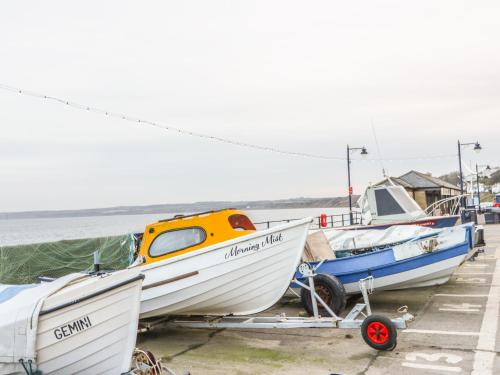 a group of boats sitting on a dock near the water at Sunrise in Filey