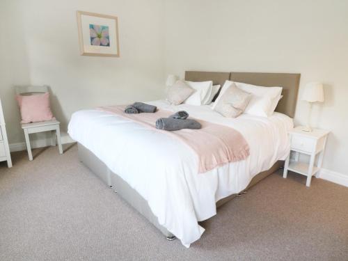 a bedroom with a large bed with two stuffed animals on it at Evergreen in Ilkley