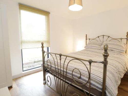 a bedroom with a bed and a window at Swan Lodge Castle Farm in Wedmore