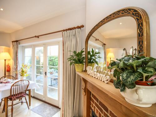 a dining room with a large mirror and a table at East Lodge in Fordingbridge