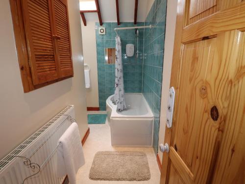 a bathroom with a toilet and a shower and a sink at Riber View Barn in Chesterfield