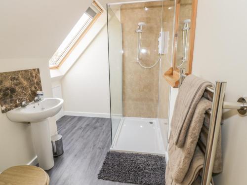 a bathroom with a shower and a sink at The Lookout in Llangarren