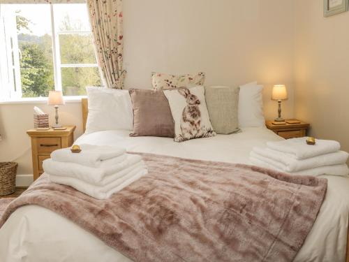 a bedroom with a bed with towels on it at 31 Riverside in Bridgnorth