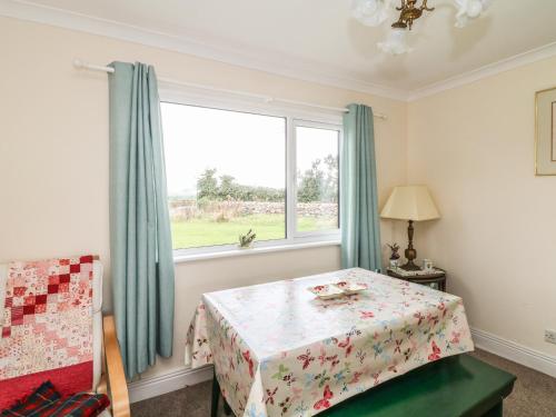 a bedroom with a table and a window at Findale in Wexford