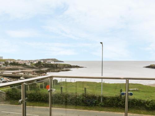 a view of the ocean from a balcony at Cable House in Cemaes Bay