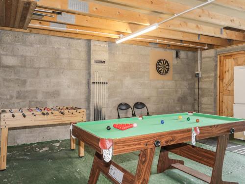 a pool table in a room with a ping pong ball at Dolce Casa in Grantown on Spey