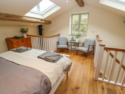 a bedroom with a bed and a table and chairs at The Stables in Huddersfield