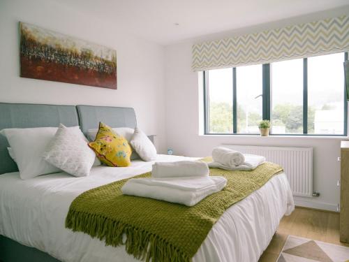a bedroom with a bed with towels on it at Sidings at Brunel Two in Lostwithiel
