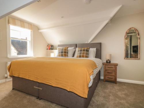 a bedroom with a large bed and a window at Postmaster's Lodging in Cheltenham