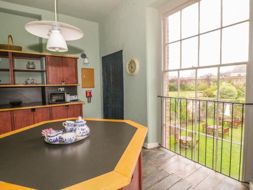 a kitchen with a table and a large window at Castle House in Taunton