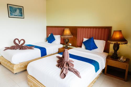 En eller flere senge i et værelse på Thipurai Beach Hotel