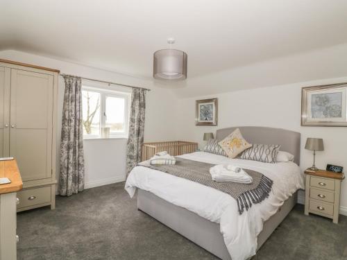 a bedroom with a bed and a window at Greenacres in Norwich