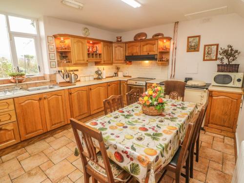 a kitchen with a table with flowers on it at Cairbre House in Dungarvan