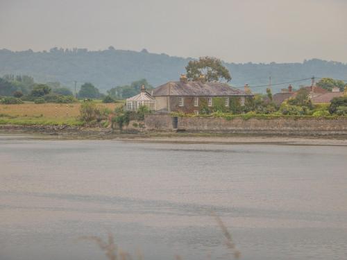 a house sitting next to a body of water at Cairbre House in Dungarvan