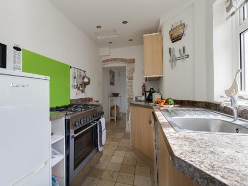 a kitchen with a sink and a stove at Fenders in Weymouth