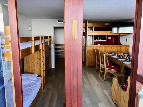 une chambre avec des lits superposés et une cuisine avec une table dans l'établissement Appartement pour 10 personnes au cœur des Arcs 1800 - Duplex 4 Pièces 10 personnes MAE-5001, à Arc 1800