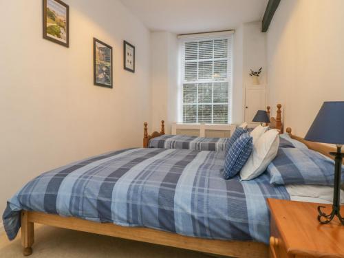 a bedroom with two beds and a window at 2 Riverside Walk in Airton