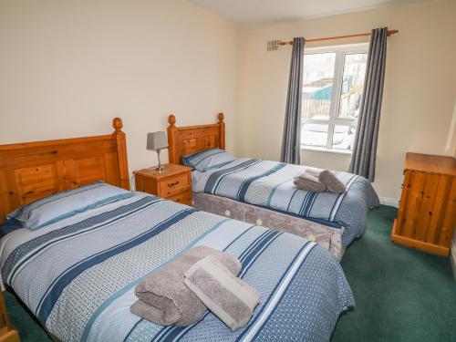 a bedroom with two beds with towels on them at Apartment 42 in Bundoran