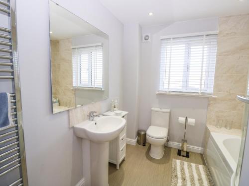 a white bathroom with a sink and a toilet at Chinefields in Freshwater