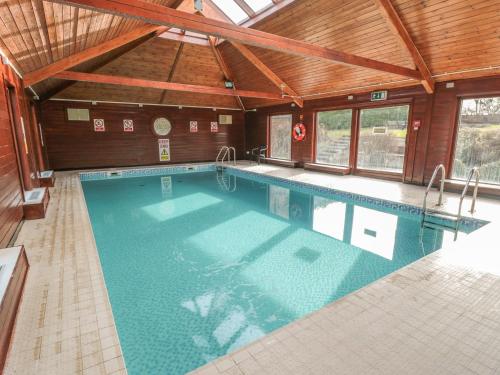 a large swimming pool in a building with a ceiling at Fauna's Corner in Whitby