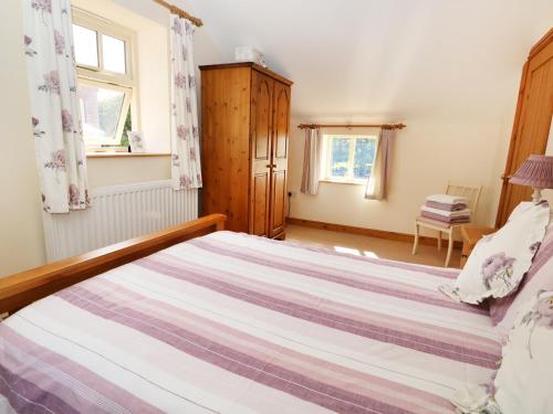a bedroom with a large bed in a room at Owl's Roost in Alford