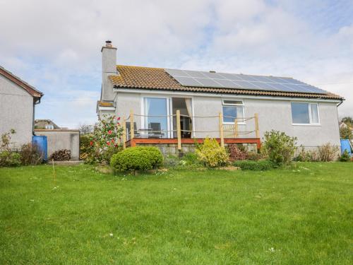 a house with solar panels on the roof at Brambles in Gorran Haven
