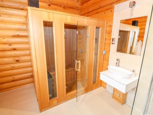 a bathroom with a sink and a glass shower at Beech Lodge in Oakham