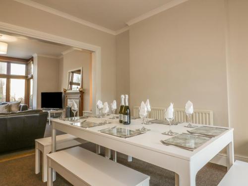 a living room with a white table with wine glasses at Chy-an-Brae in Newquay
