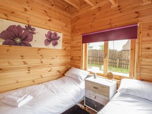Ένα ή περισσότερα κρεβάτια σε δωμάτιο στο Sunnyside Lodge
