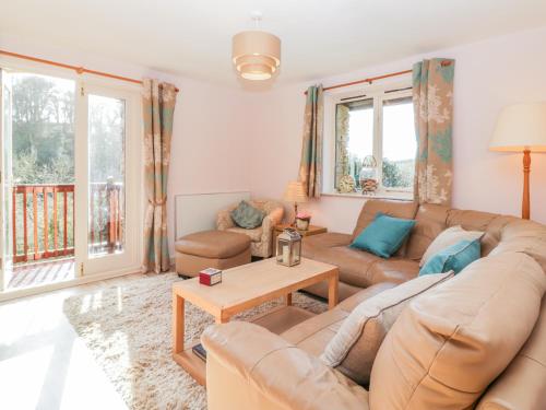 a living room with a couch and a table at Bearscombe in Ivybridge