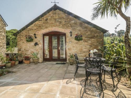 a church with a table and chairs in front of it at Bearscombe in Ivybridge