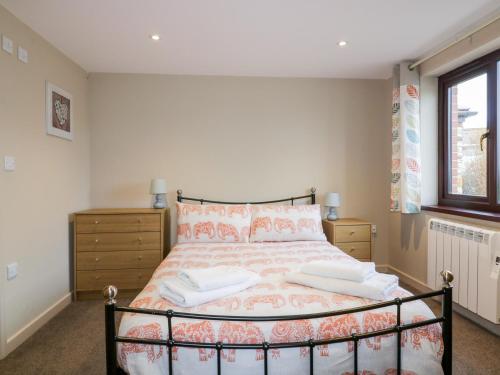 a bedroom with a bed and a window at Little May in Newquay