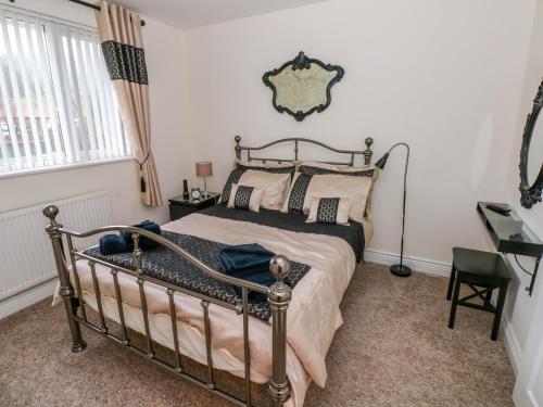 a bedroom with a bed and a mirror on the wall at Ty Cerrig in Ammanford