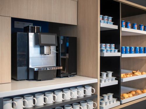 a kitchen with a coffee maker in a store at Holiday Inn Express Changchun Jingyue by IHG in Changchun