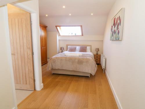 a bedroom with a bed and a skylight at Llain Haf in Llangefni