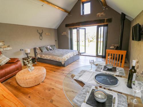 a living room with a bed and a table at Thompson Rigg Barn in Scarborough