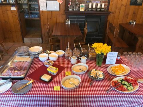 a red and white checkered table with food on it at Penzion Slunečnice in Rokytnice nad Jizerou
